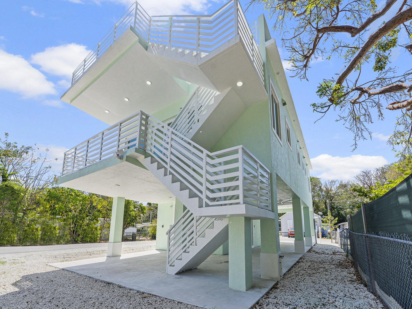 101 Kay Drive Key Largo, FL 33037 - Photo 4 of 71 a front view of a house with a yard