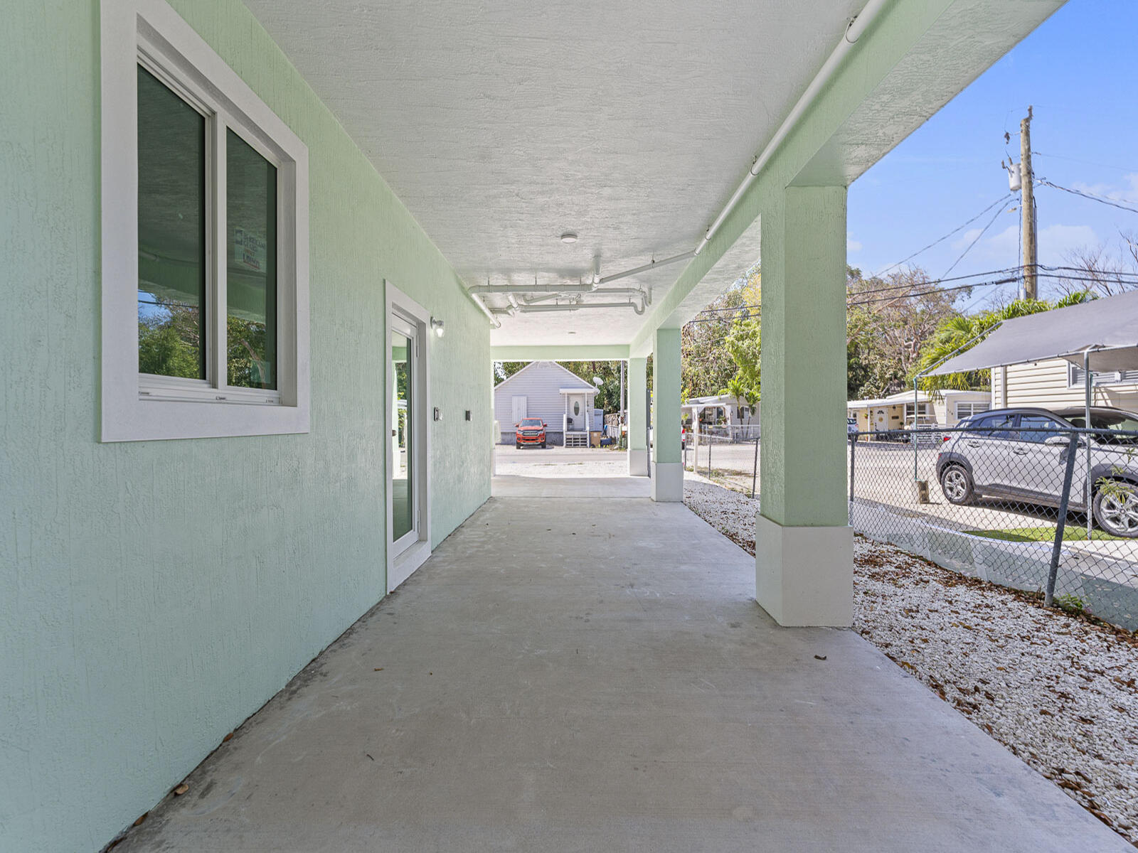 101 Kay Drive Key Largo, FL 33037 - Photo 46 of 71 a view of a porch with furniture and floor to ceiling window