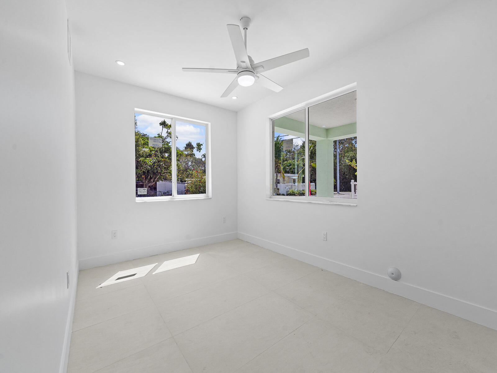 101 Kay Drive Key Largo, FL 33037 - Photo 49 of 71 en empty room with windows and ceiling fan