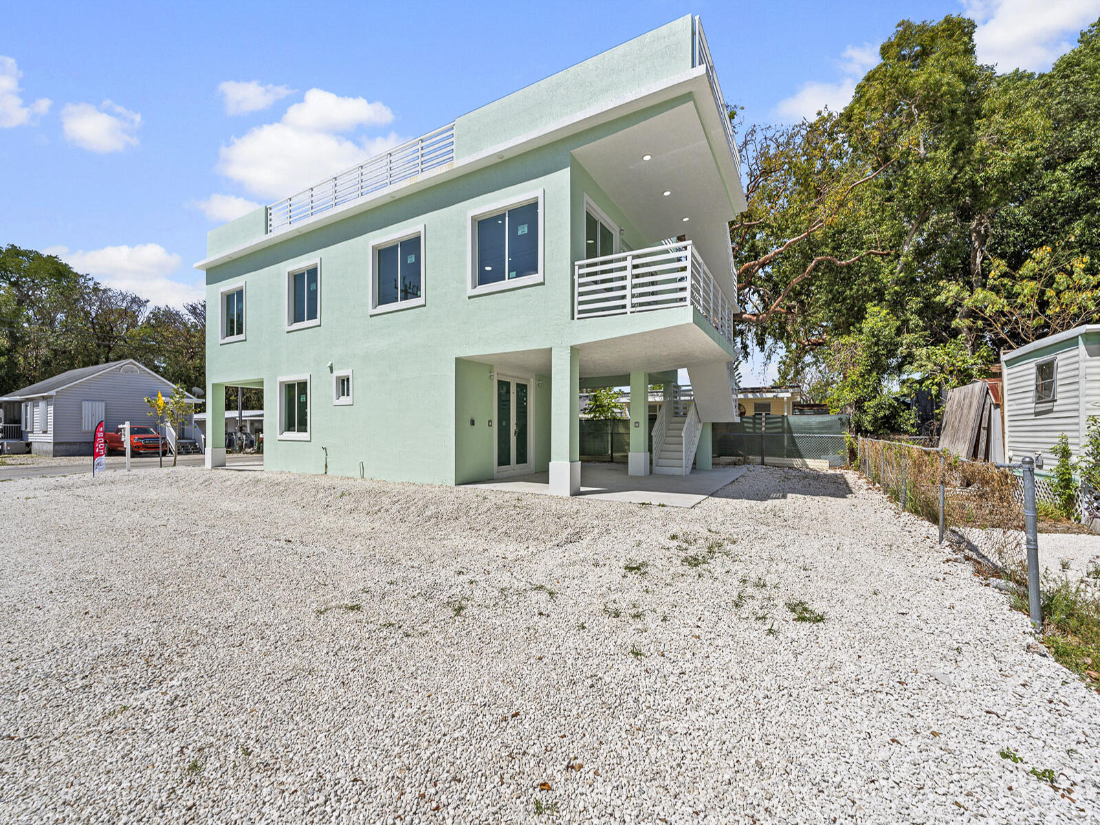 101 Kay Drive Key Largo, FL 33037 - Photo 55 of 71 a view of a house with a yard and a large tree