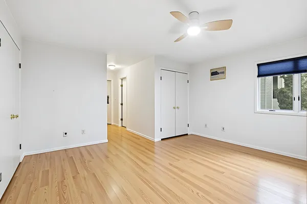 a spacious bedroom with a bed and a window