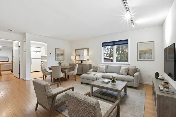 a living room with furniture a large window and a flat screen tv