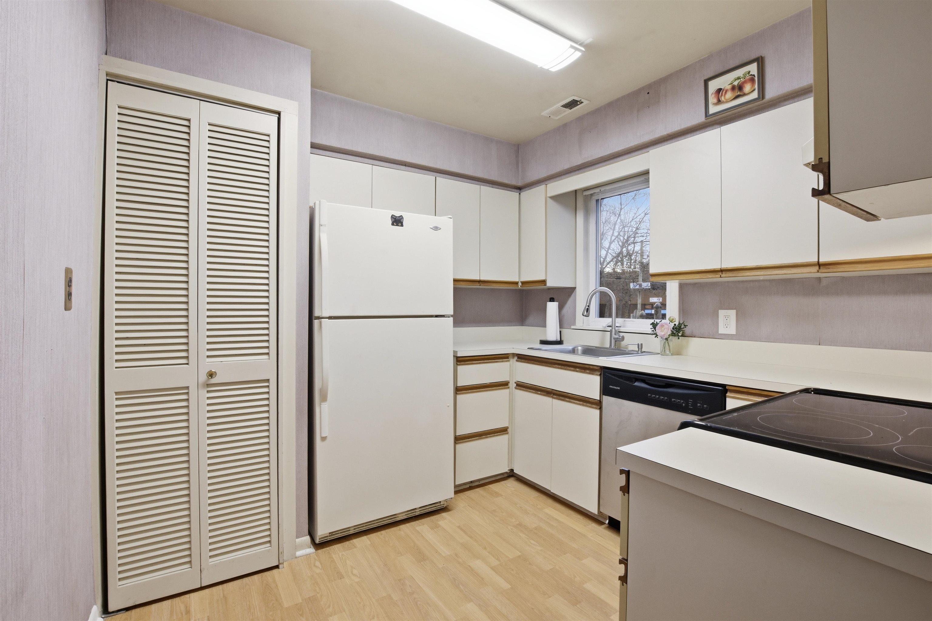 700 10th Street, Unit 1 Secaucus, NJ 07094 - Photo 7 of 21 a kitchen with a refrigerator sink and cabinets