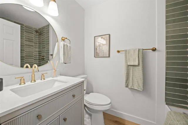 a bathroom with a sink a toilet and mirror