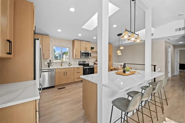 a kitchen with a sink a stove cabinets and counter space