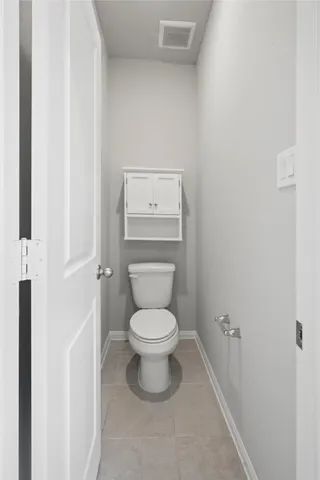 a white toilet sitting next to a white sink