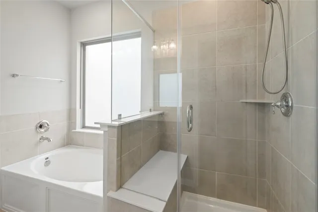 a bathroom with a bathtub and shower