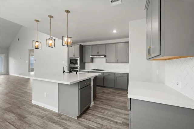 a kitchen with a sink a window and stainless steel appliances