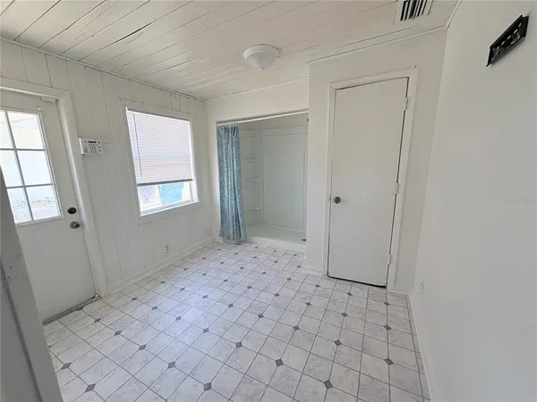 a view of a bedroom with a hardwood floor and window