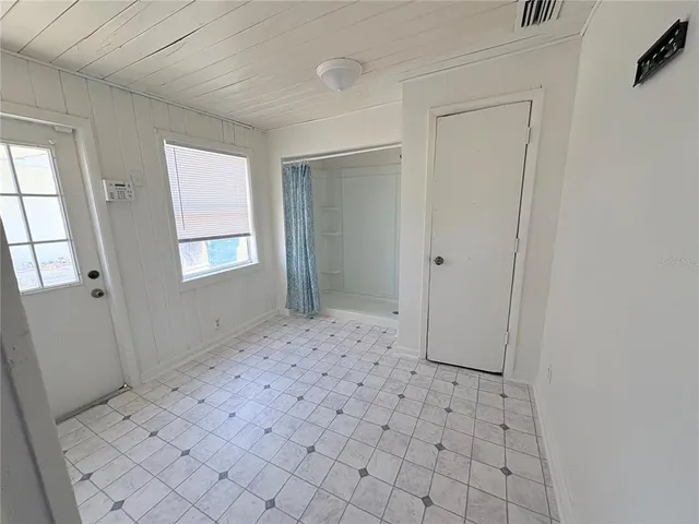 a view of a bedroom with a hardwood floor and window