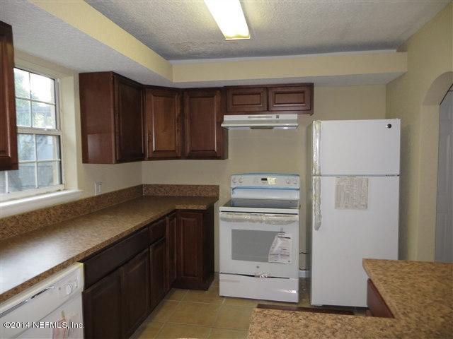 2518 Sam Road Jacksonville, FL 32216 - Photo 3 of 7 a kitchen with a refrigerator and cabinets