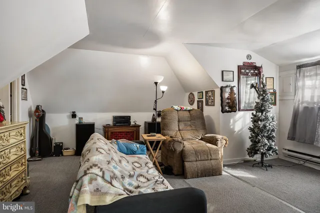 a bedroom with furniture and a flat screen tv