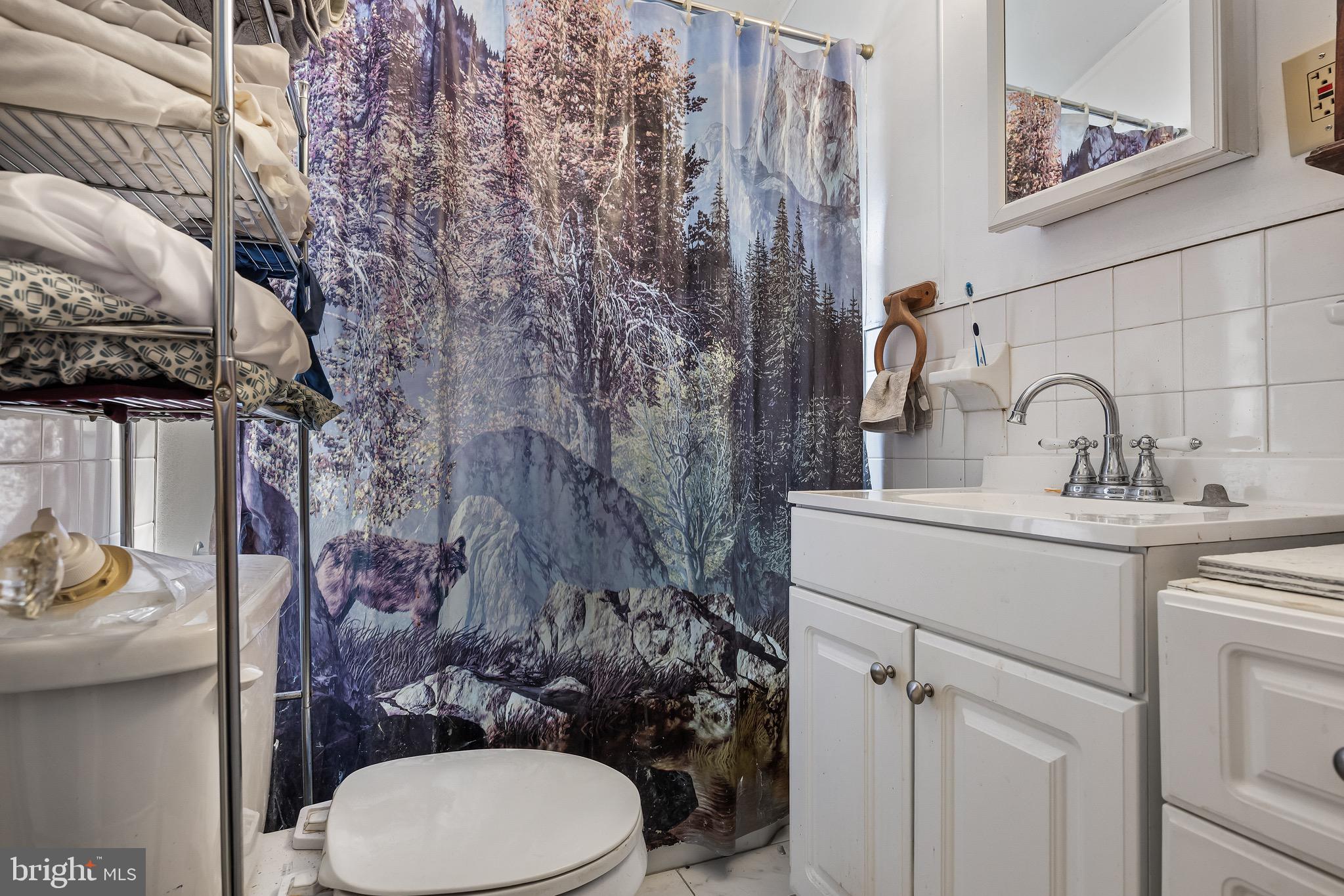 303 Pine Street Carneys Point, NJ 08069 - Photo 16 of 34 a bathroom with a toilet sink and mirror