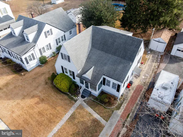 an aerial view of a house with garden space and street view