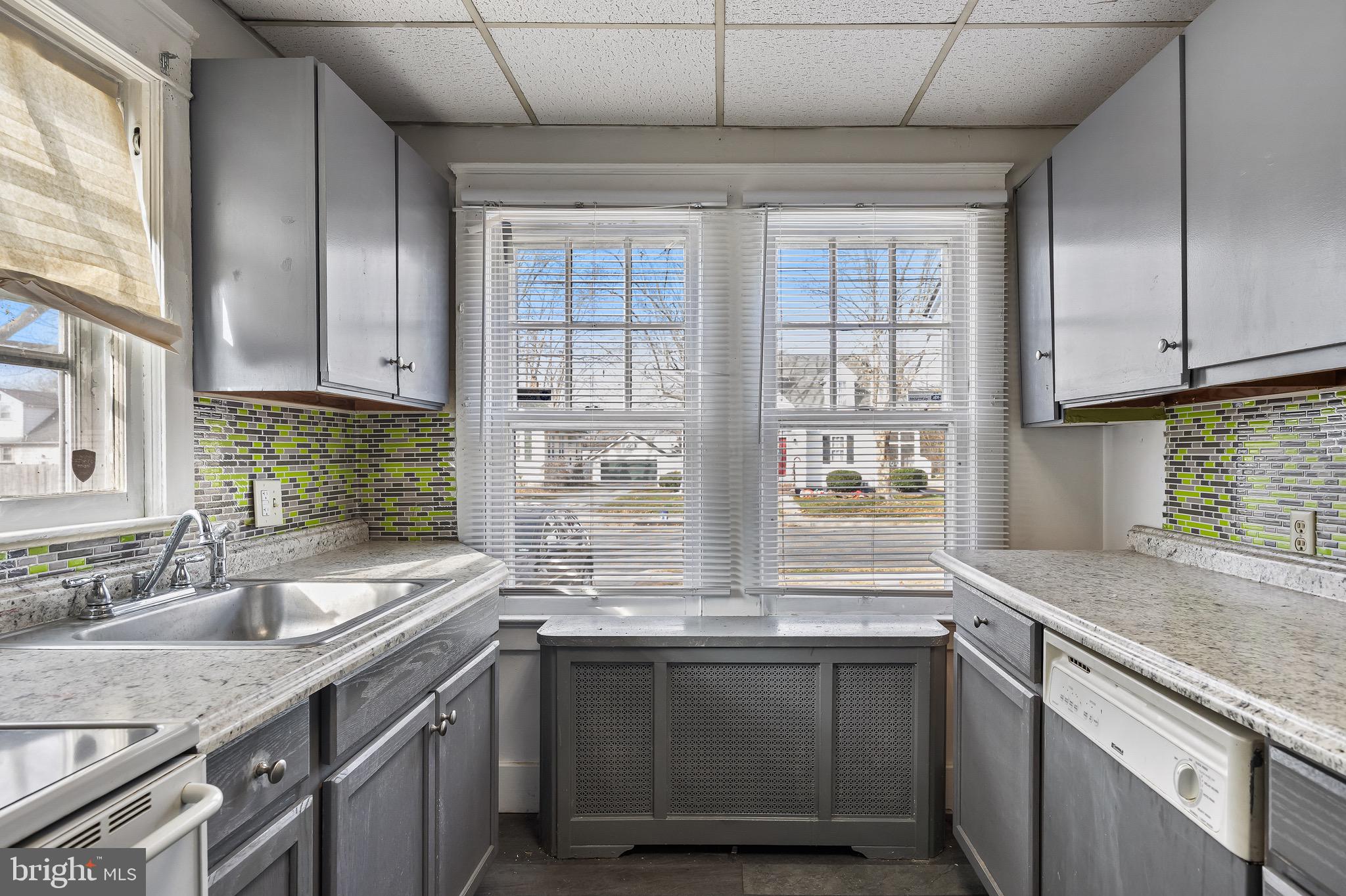 303 Pine Street Carneys Point, NJ 08069 - Photo 8 of 34 a kitchen with granite countertop a sink and a window