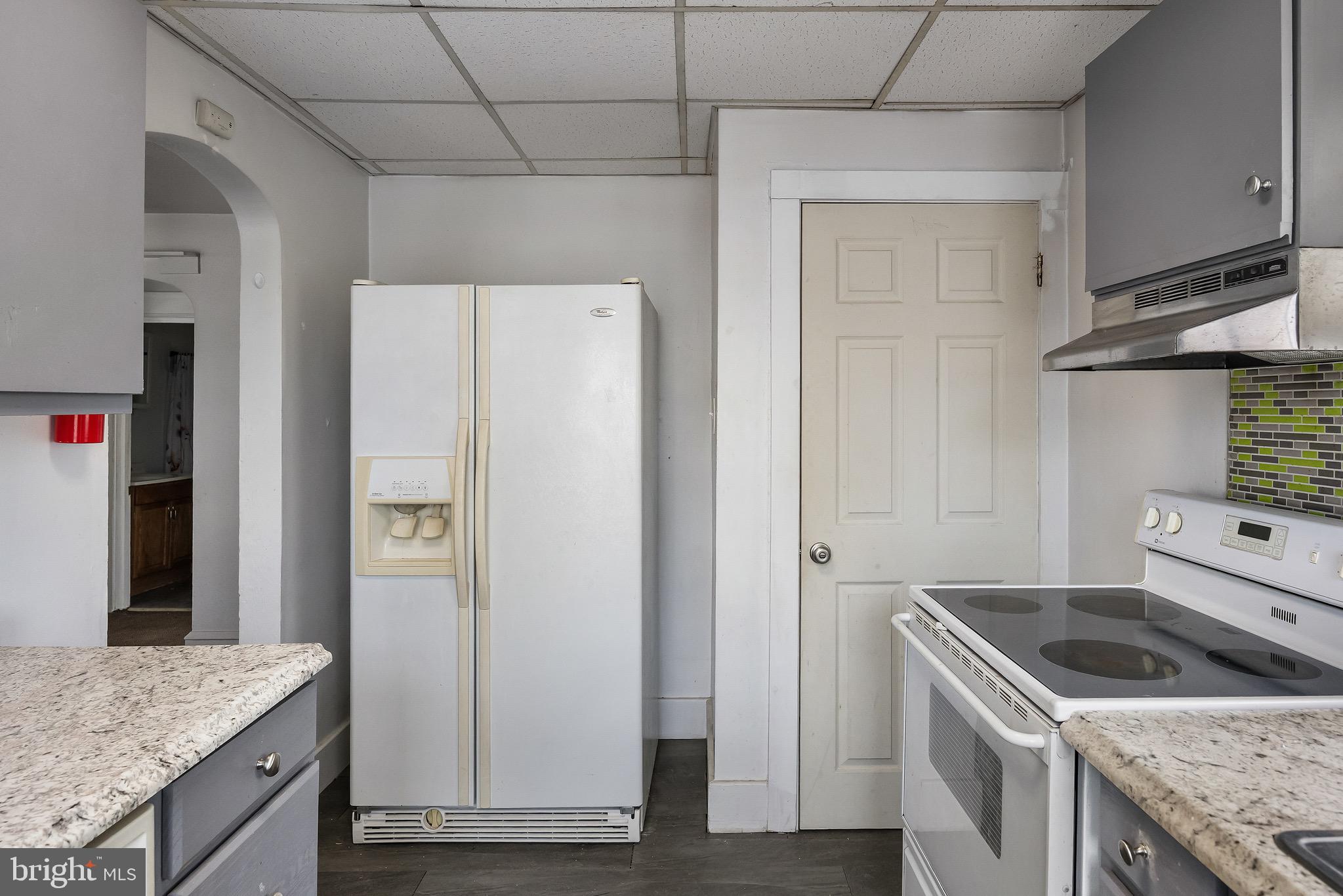 303 Pine Street Carneys Point, NJ 08069 - Photo 9 of 34 a kitchen with granite countertop a refrigerator and a sink