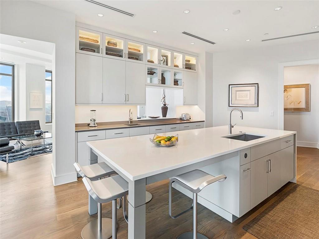 3376 Peachtree Road Northeast, Unit 44B Atlanta, GA 30326 - Photo 20 of 58 a kitchen with a sink a stove and chairs