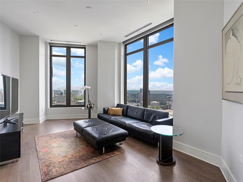 3376 Peachtree Road Northeast, Unit 44B Atlanta, GA 30326 - Photo 22 of 58 a living room with furniture and a floor to ceiling window