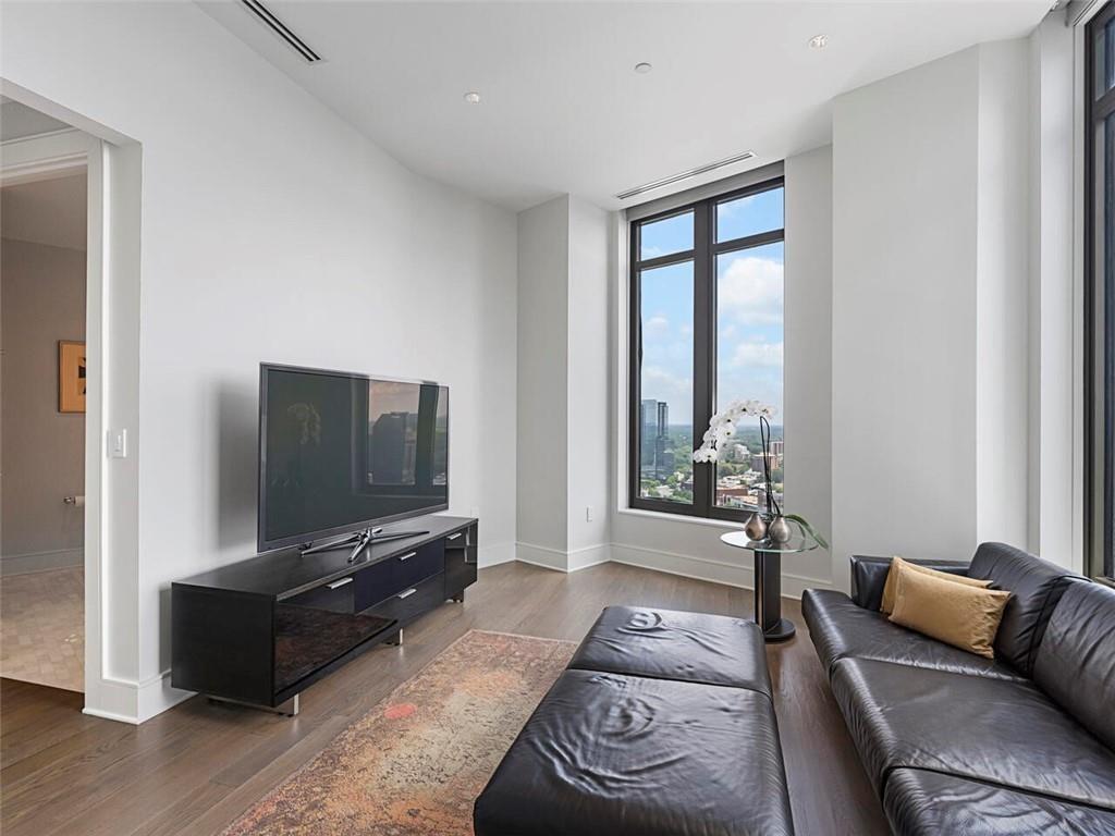 3376 Peachtree Road Northeast, Unit 44B Atlanta, GA 30326 - Photo 23 of 58 a living room with furniture and a flat screen tv