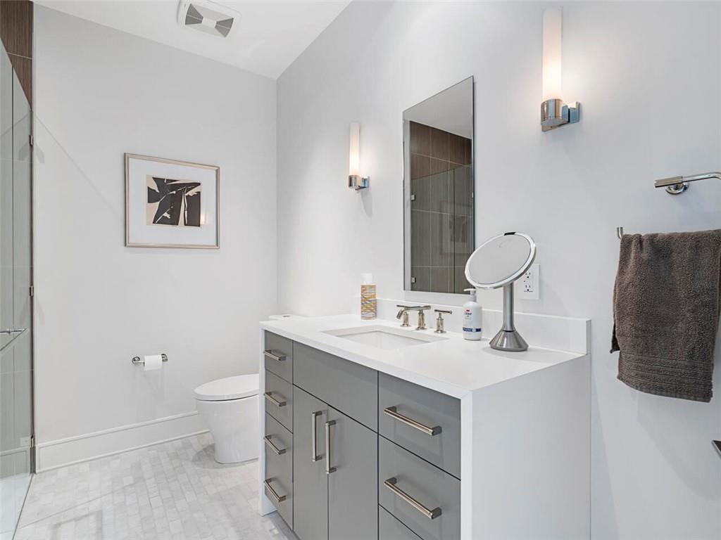 3376 Peachtree Road Northeast, Unit 44B Atlanta, GA 30326 - Photo 24 of 58 a bathroom with a toilet sink and mirror