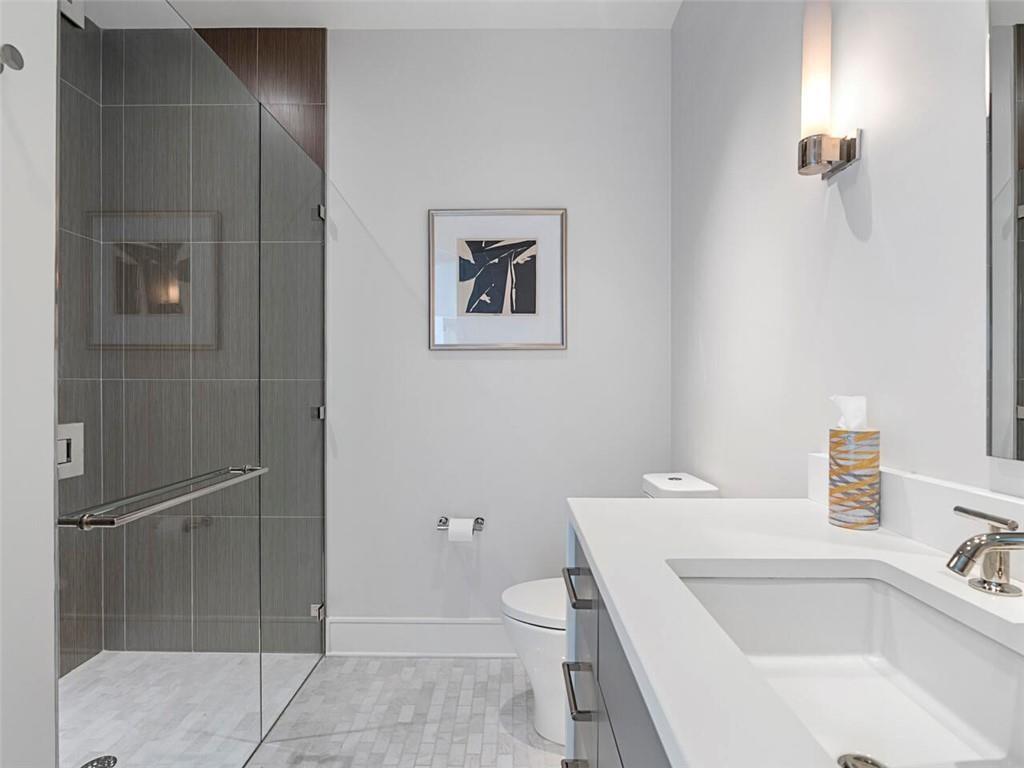 3376 Peachtree Road Northeast, Unit 44B Atlanta, GA 30326 - Photo 33 of 58 a bathroom with a sink and toilet