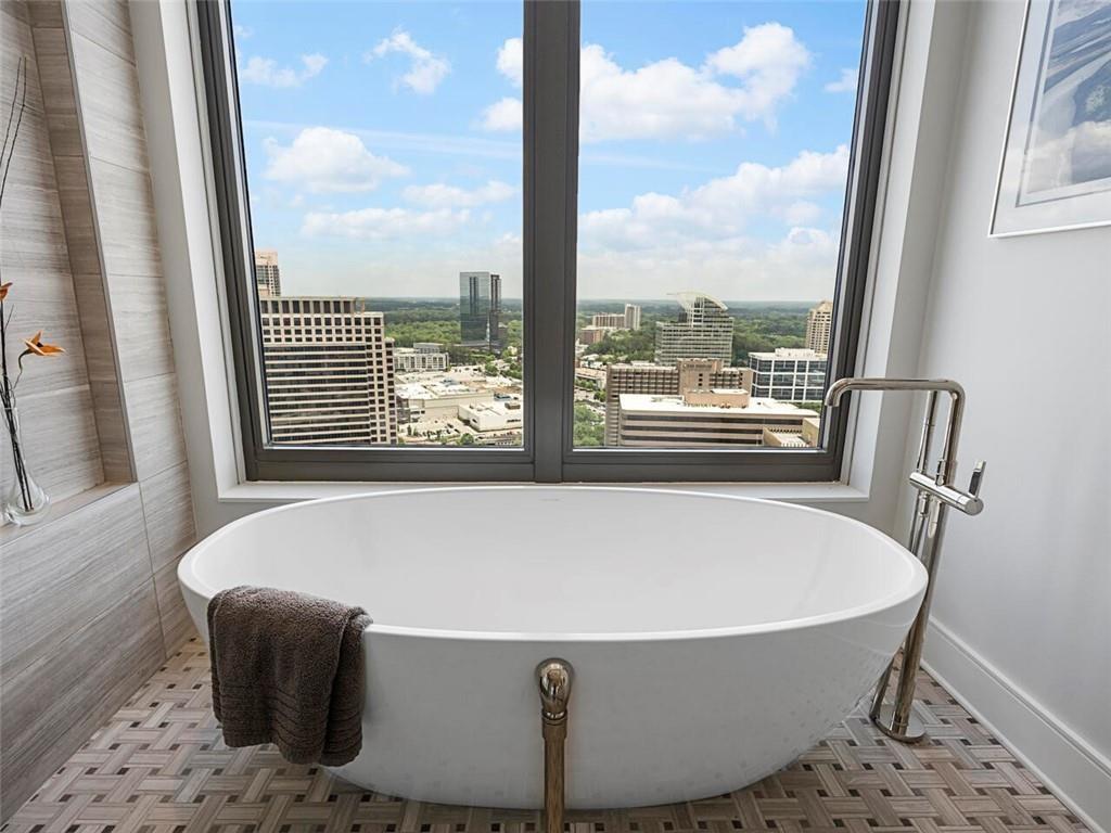 3376 Peachtree Road Northeast, Unit 44B Atlanta, GA 30326 - Photo 38 of 58 a white bath tub sitting in a bathroom next to a window