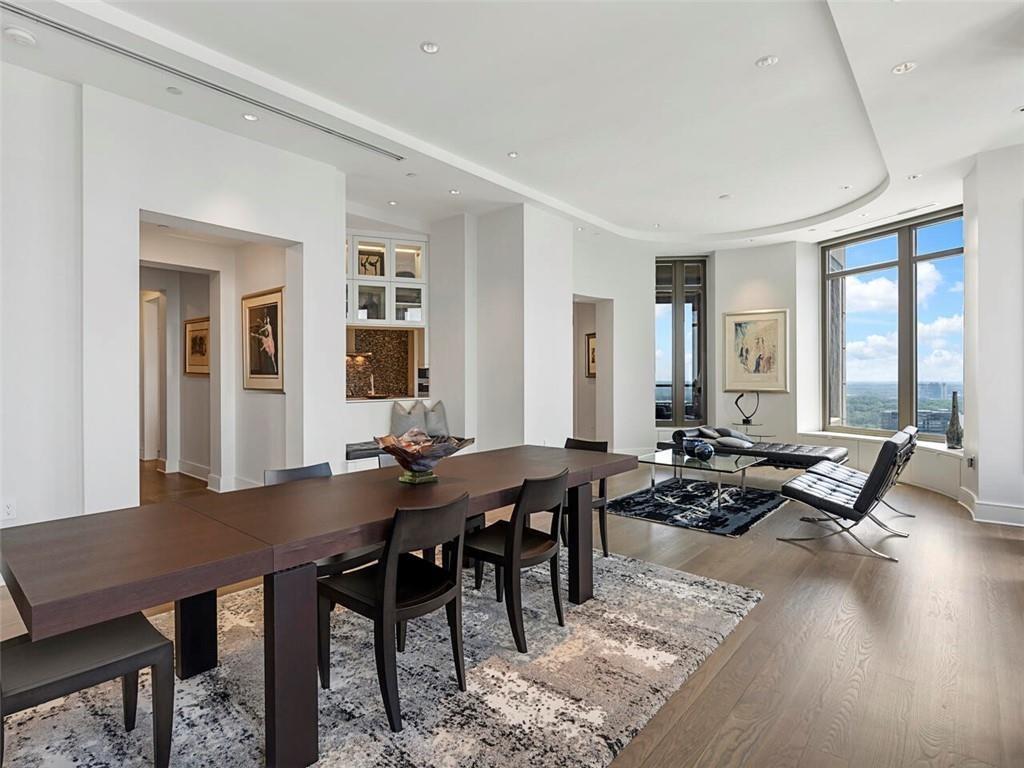 3376 Peachtree Road Northeast, Unit 44B Atlanta, GA 30326 - Photo 4 of 58 a view of a dining room with furniture large windows and wooden floor