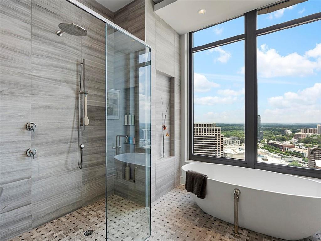 3376 Peachtree Road Northeast, Unit 44B Atlanta, GA 30326 - Photo 41 of 58 a bathroom with a granite countertop sink a toilet and shower