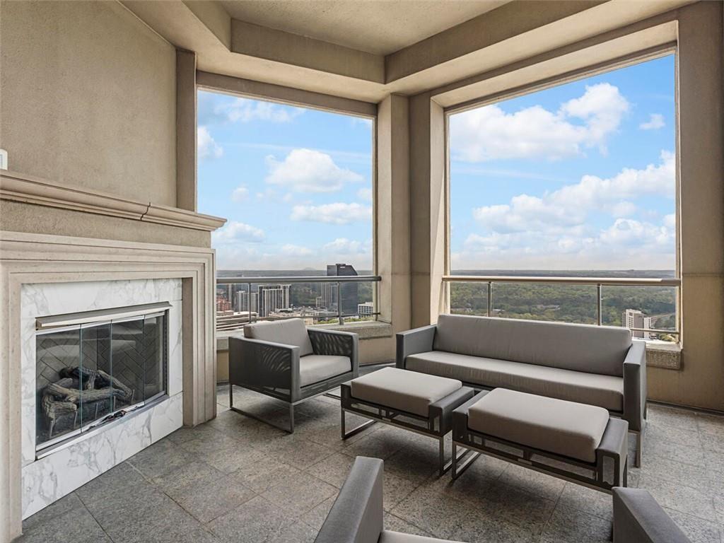 3376 Peachtree Road Northeast, Unit 44B Atlanta, GA 30326 - Photo 42 of 58 a living room with furniture a floor to ceiling window and a fireplace