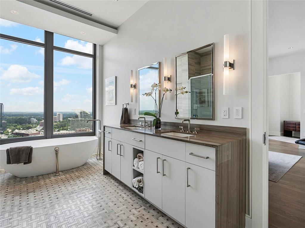 3376 Peachtree Road Northeast, Unit 44B Atlanta, GA 30326 - Photo 46 of 58 a spacious bathroom with a granite countertop sink and a large mirror