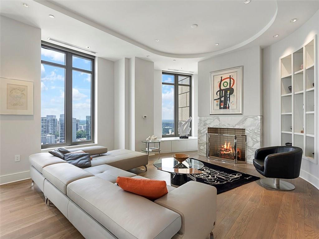 3376 Peachtree Road Northeast, Unit 44B Atlanta, GA 30326 - Photo 5 of 58 a living room with furniture large window and a fireplace