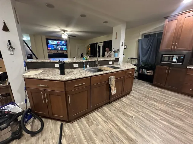 a kitchen with a sink appliances and cabinets