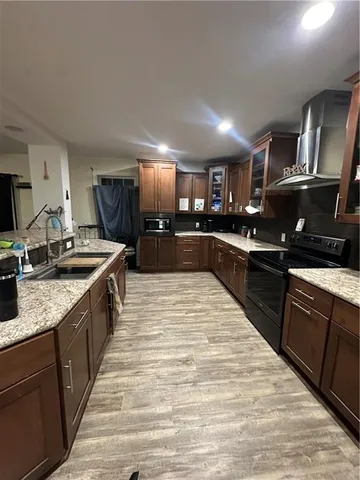 a large kitchen with stainless steel appliances kitchen island granite countertop a large counter top and stove