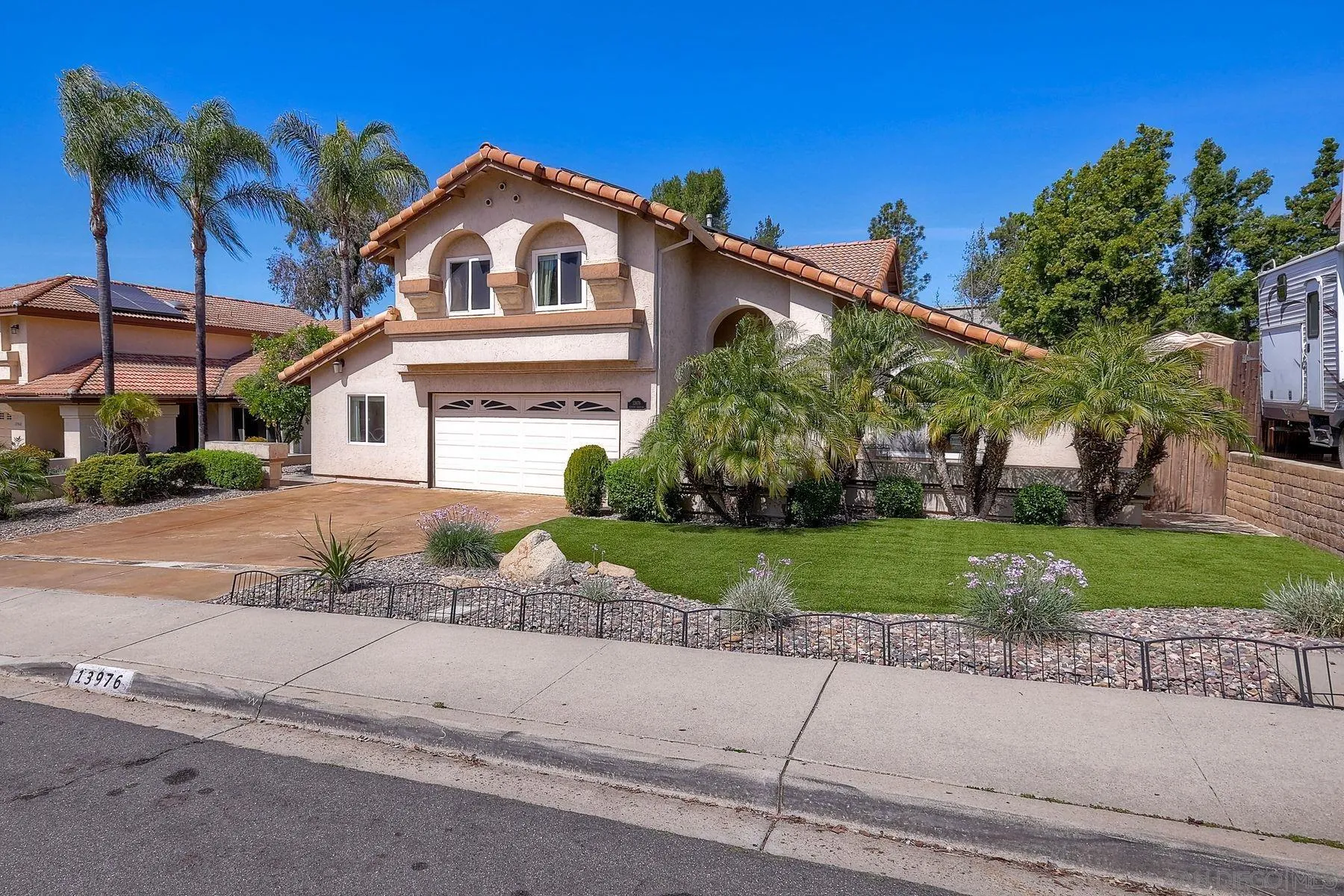 13976 Country Creek Road Poway, CA 92064 - Photo 2 of 40 a front view of a house with a yard and a garage