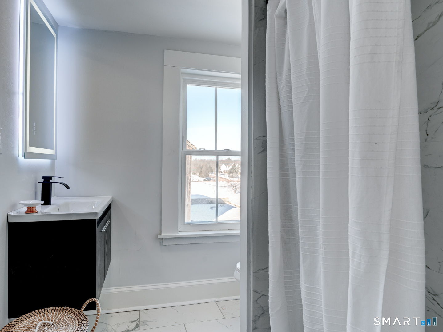 76 Griffin Road East Windsor, CT 06016 - Photo 25 of 35 a bathroom with a sink a mirror and a window