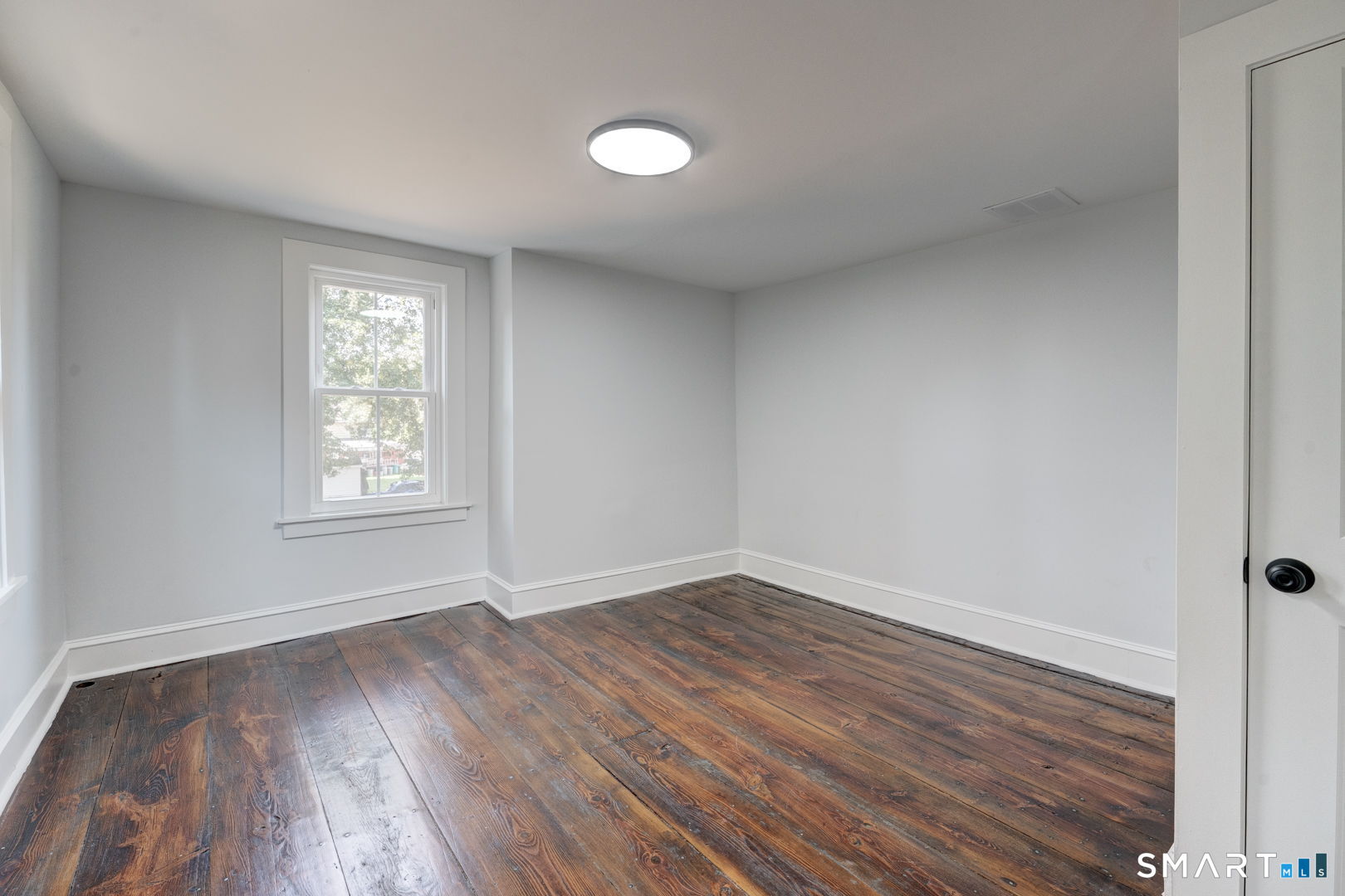 76 Griffin Road East Windsor, CT 06016 - Photo 29 of 35 wooden floor in an empty room with a window