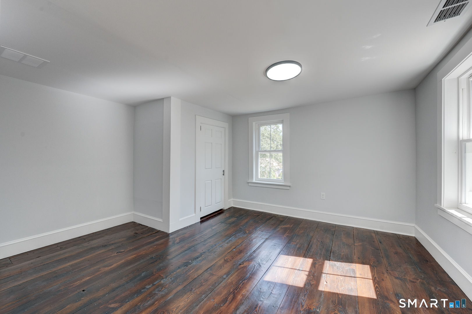 76 Griffin Road East Windsor, CT 06016 - Photo 30 of 35 an empty room with wooden floor and windows