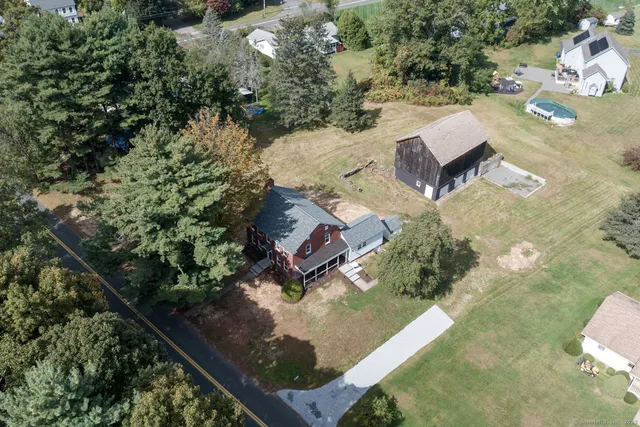 an aerial view of a house with a yard