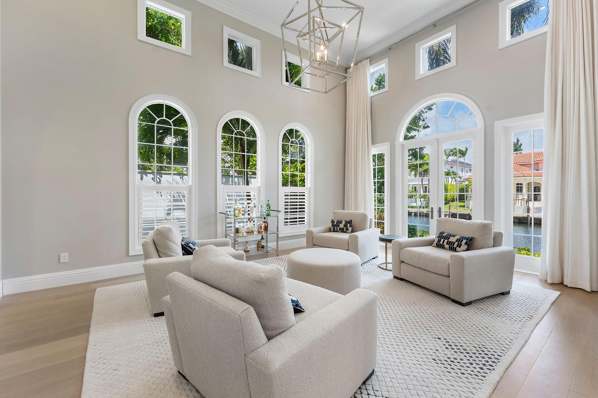 251 Coconut Palm Road Boca Raton, FL 33432 - Photo 26 of 97 a living room with furniture a chandelier and a large window