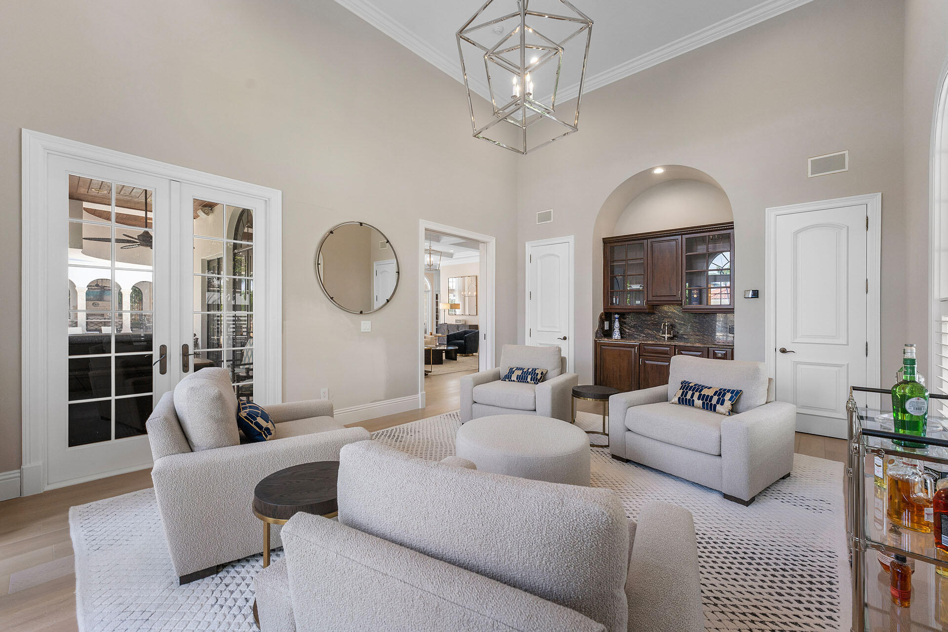 251 Coconut Palm Road Boca Raton, FL 33432 - Photo 27 of 97 a living room with furniture a chandelier and a large mirror