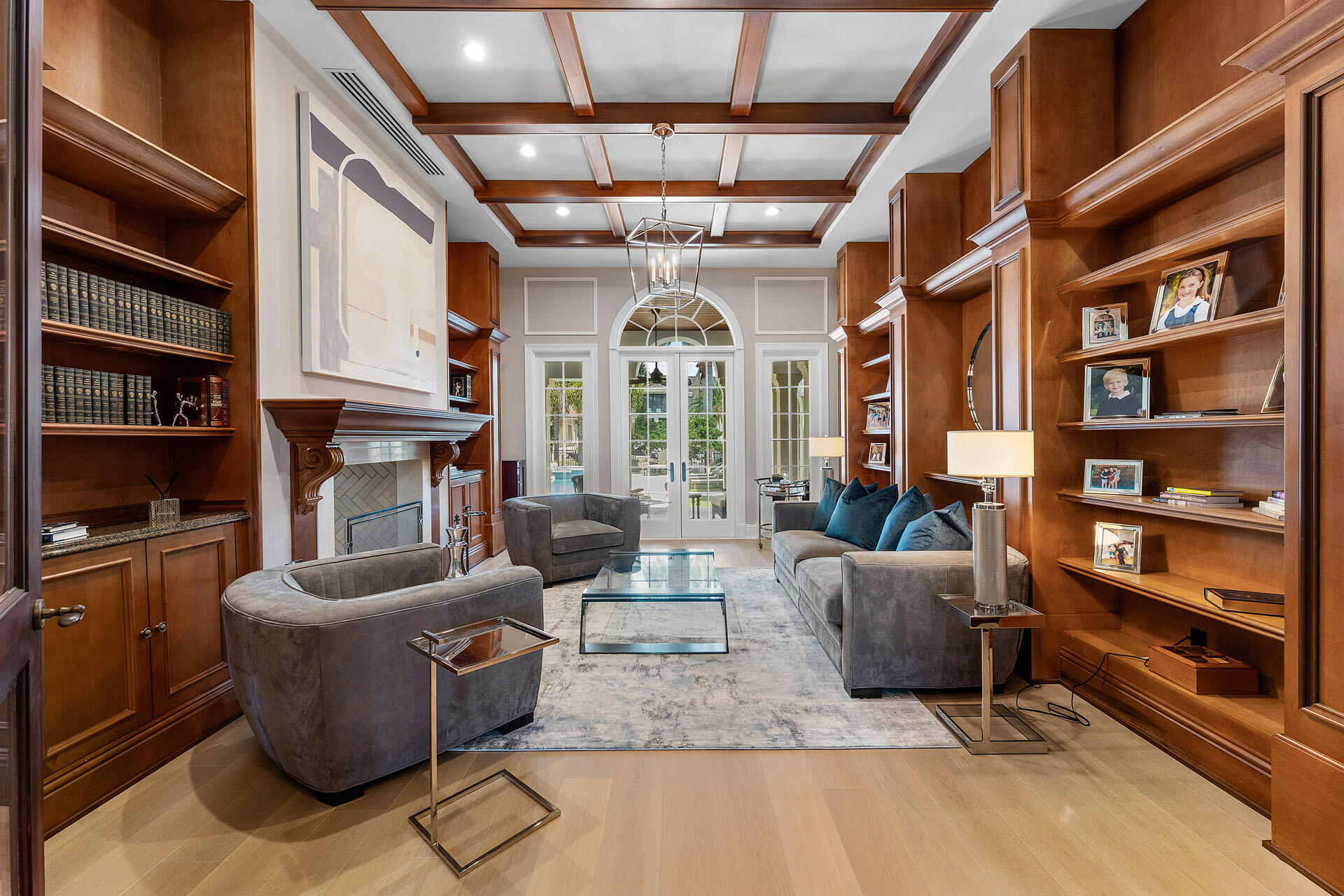 251 Coconut Palm Road Boca Raton, FL 33432 - Photo 39 of 97 a living room with furniture a bookshelf and a large window