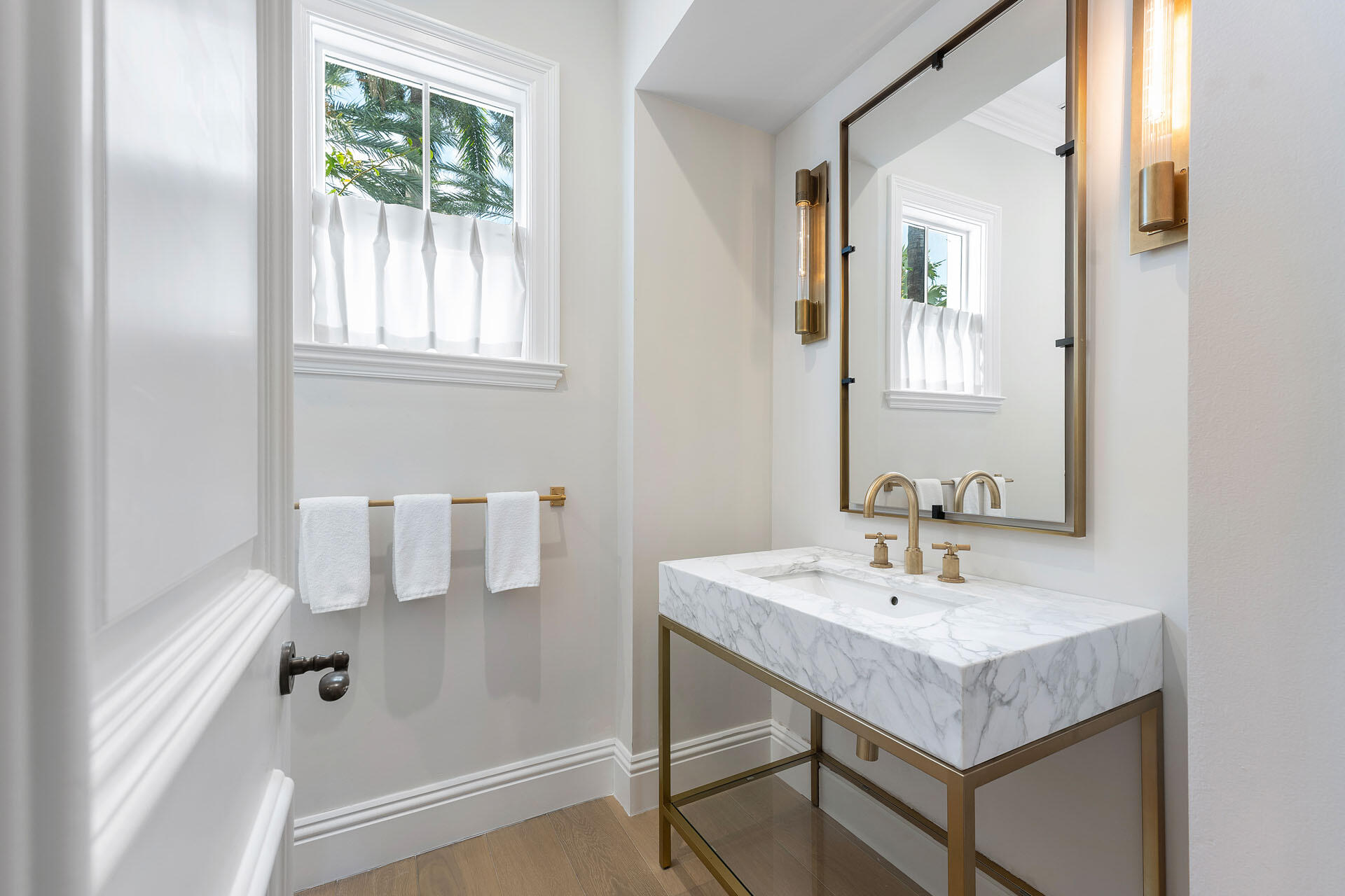 251 Coconut Palm Road Boca Raton, FL 33432 - Photo 42 of 97 a bathroom with a sink and a mirror