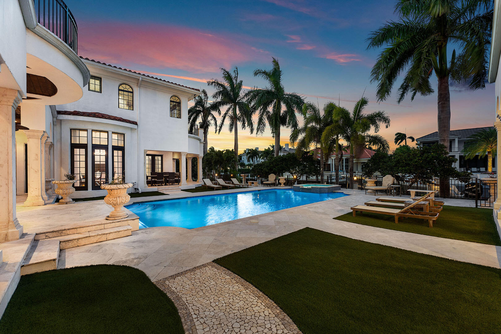 251 Coconut Palm Road Boca Raton, FL 33432 - Photo 77 of 97 a view of a swimming pool with lounge chair and palm trees