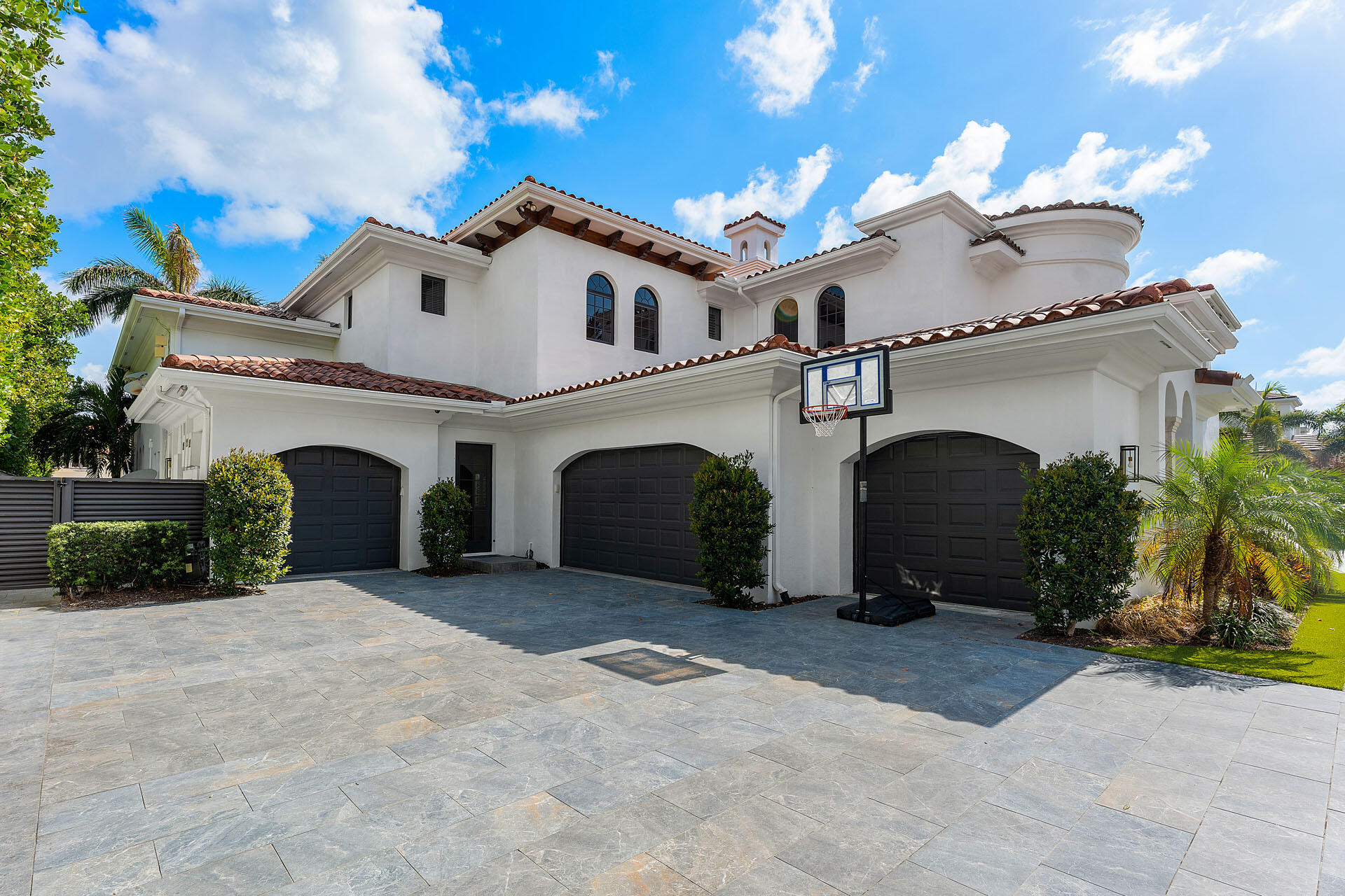 251 Coconut Palm Road Boca Raton, FL 33432 - Photo 8 of 97 a view of a white house with a large space and a yard