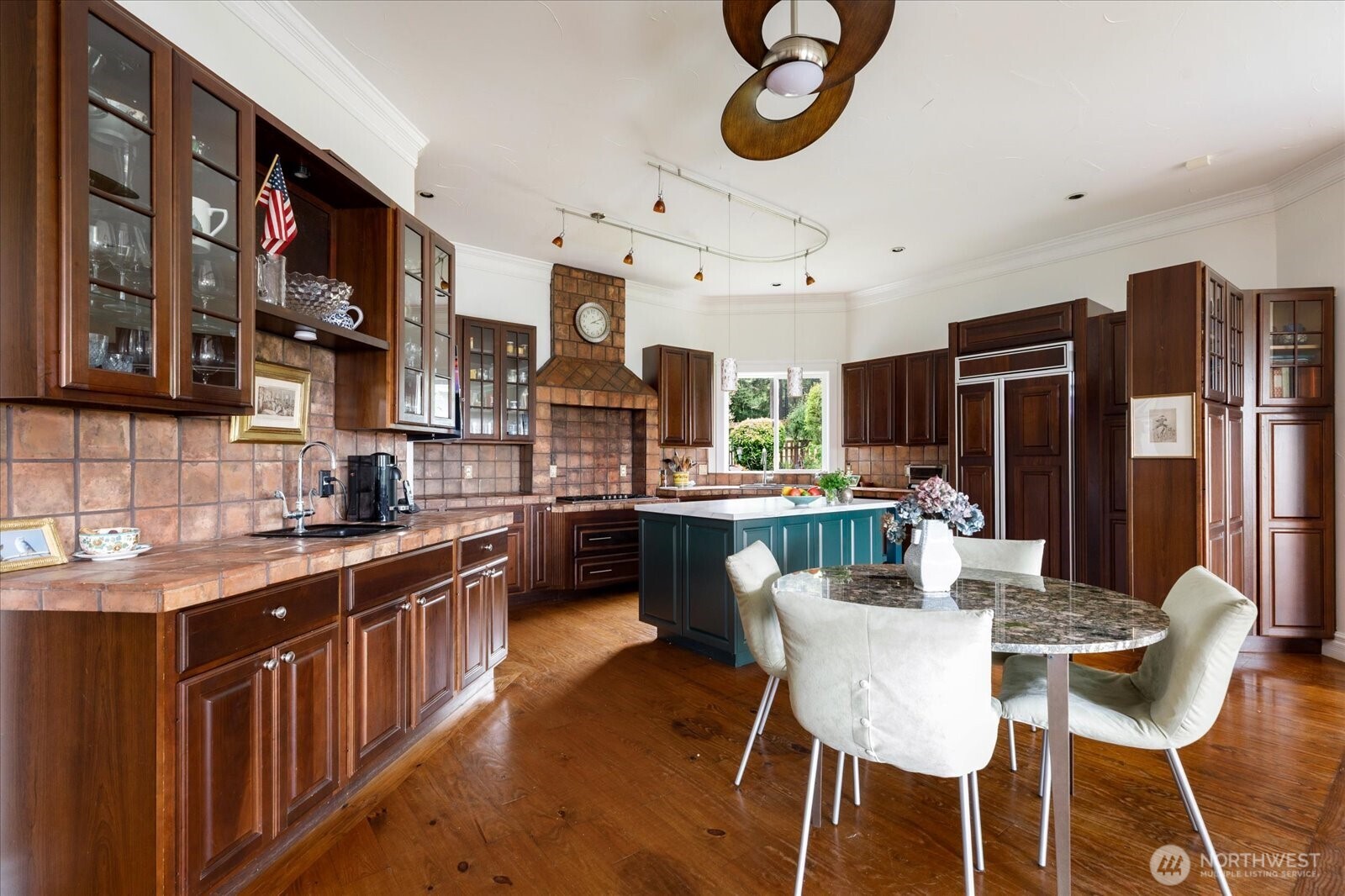 5427 Bayview Road Langley, WA 98260 - Photo 13 of 40 a kitchen with stainless steel appliances granite countertop a sink a stove a refrigerator cabinets and chairs