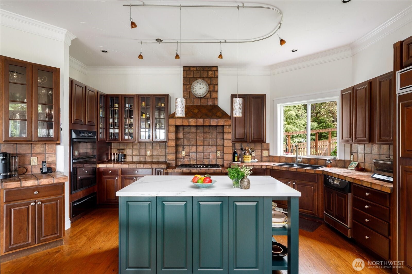 5427 Bayview Road Langley, WA 98260 - Photo 14 of 40 a kitchen with a sink stove and cabinets