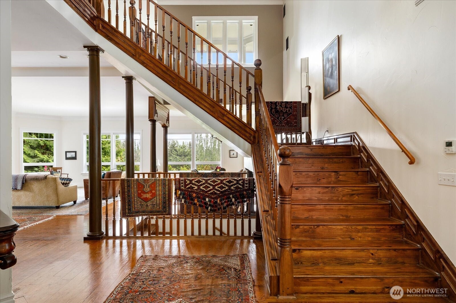 5427 Bayview Road Langley, WA 98260 - Photo 21 of 40 a view of staircase with lots of frames on wall and a large window