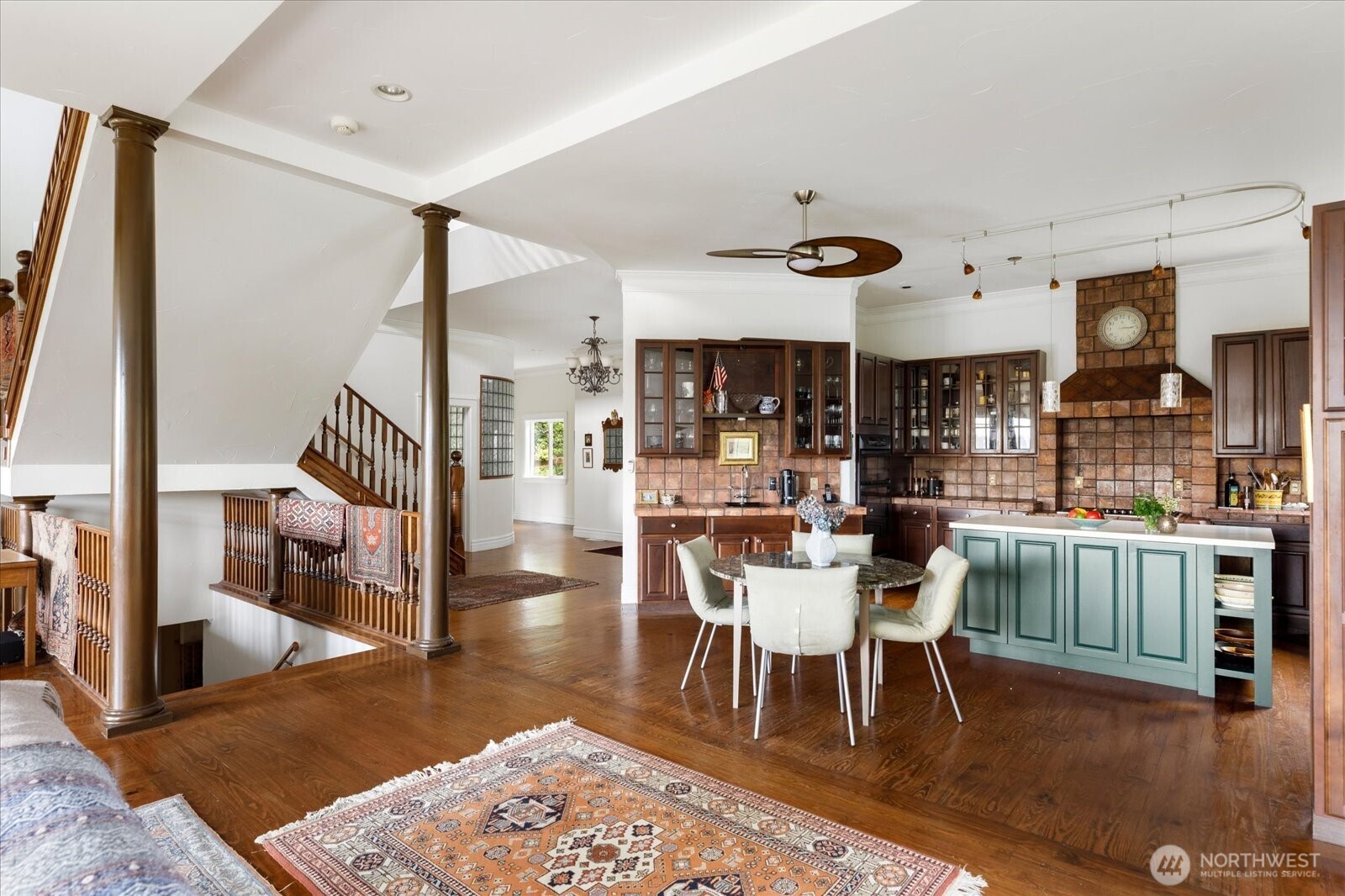 5427 Bayview Road Langley, WA 98260 - Photo 27 of 40 a dining room with wooden floor and a rug