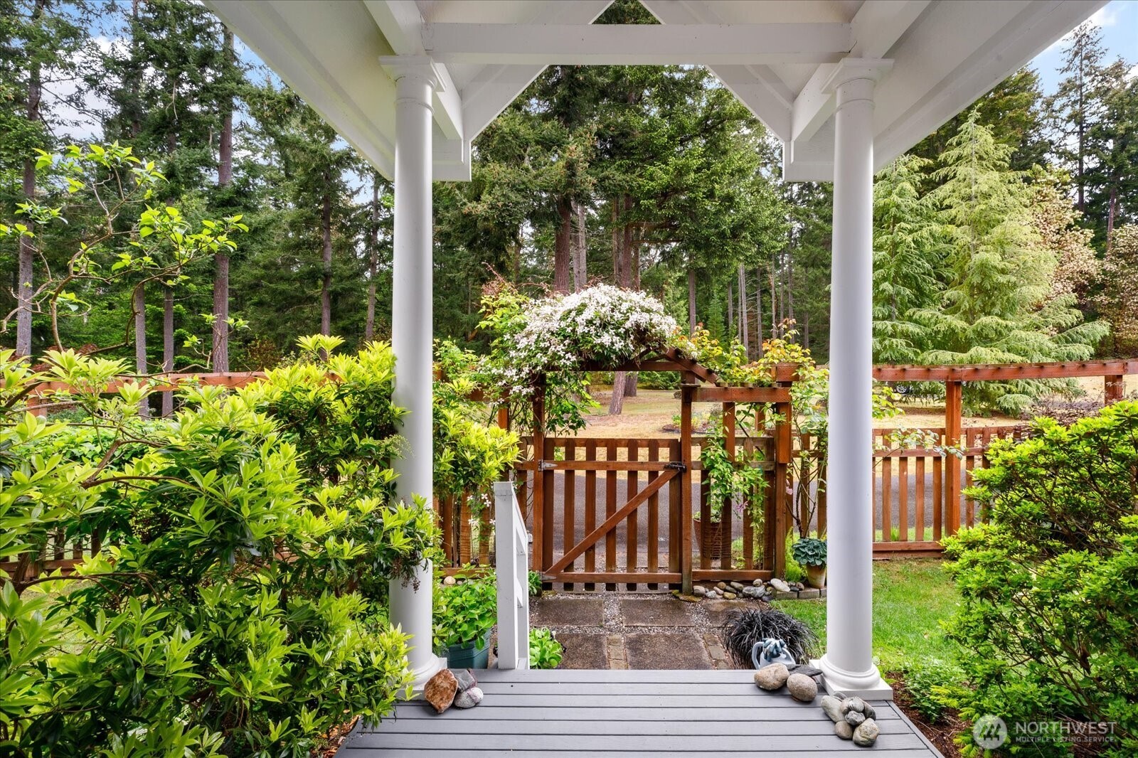 5427 Bayview Road Langley, WA 98260 - Photo 8 of 40 a view of a porch with a table and chair and floor to ceiling window