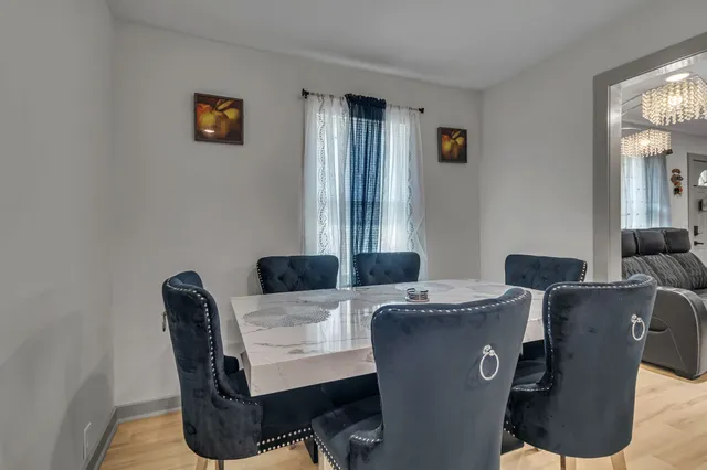 a view of a dining room with furniture and a window